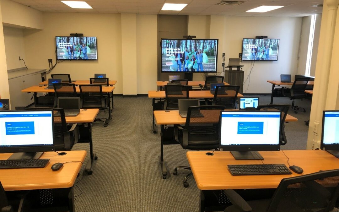 Monitors and desks at the tech hub